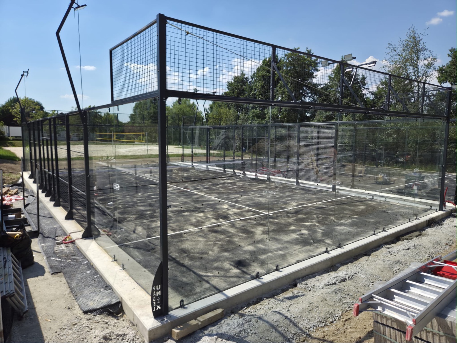 Montage der Stahlstruktur und Glaswände eines Padel-Courts